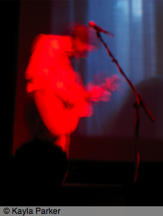 Kayla's photo of Alasdair Roberts playing the guitar and singing on stage at Norwich Arts Centre