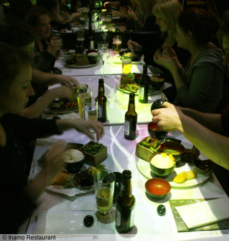 frame from Kayla's Animate film Sunset Strip projected onto the tables of diners at Inamo Restaurant, Soho, during the London Short Film Festival 9 January 2011