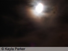Photo of the gibbous moon in light cloud, hand-held long exposure