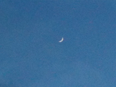 new crescent moon in blank sky, a few seconds later